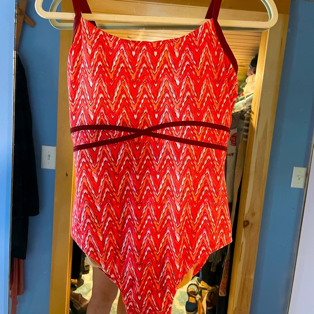 One piece size 8 orange patterned suit.